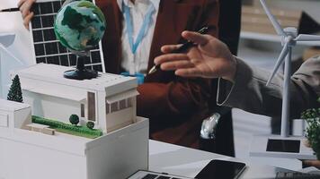 Green energy business company meeting with business people planning and discuss marketing of sustainable and renewable clean energy product with solar cell and wind turbine generator. Trailblazing video