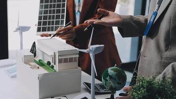 Green energy business company meeting with business people planning and discuss marketing of sustainable and renewable clean energy product with solar cell and wind turbine generator. Trailblazing video
