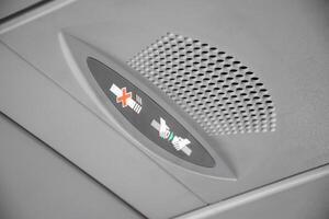 Symbol light of take belt and no smoking on the airplane, Interior of an airplane, Cabin sign light of no smoking and fasten seatbelt while airplane take off and landing 2025. photo