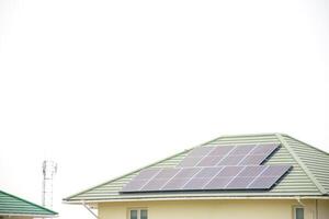 Installing a solar cell on a roof. Solar panels on roof. Modern house with modern solar panels on tile roof and wall against clear sky background 2025. photo