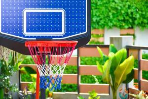 Blue and red basketball hoop for basketball games in playground on nature background. photo