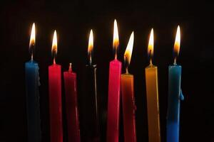 A set of lit Hanukkah candles lined up. In the form of dark, foreboding, contrasting colors. photo