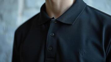 Close-up of a simple black polo shirt. By emphasizing details on the front contrasting with the white background. photo