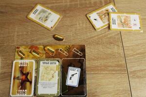 board game bang. Loss of bullet life by the player after attacking an opponent photo