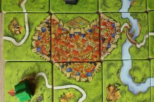 board game carcassonne funny shapes of heart cities. Meeple Scoring Rules on the Monastery Top View photo
