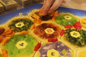 A catan board game to increase the level of settlement in the city. Buying Resources and Development Cards photo