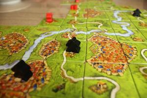 black meeple on the map of the game carcassonne. Road Scoring Rules photo