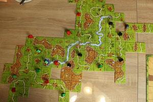 board game carcassonne laid out tiles and meeples on the map top view Gameplay photo