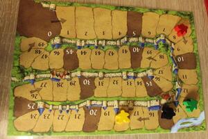 Tablet for calculating the progress of players in the board family game Carcassonne. Red Yellow Melinated Black Meeple on Tablet. Gameplay photo