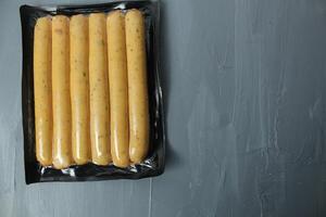sausages in a package on a gray background top view. Food Safety Packaging photo
