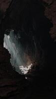 A mesmerizing cave with a ray of sunlight streaming through a small opening video
