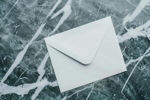 White blank envelope on gray marble table background. Top view photo