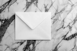 White blank envelope on gray marble table background. Top view photo