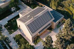 New suburban house with a photovoltaic system on the roof. Modern eco friendly passive house with solar panels on the gable roof photo