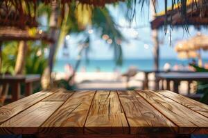 Empty wooden table top with copy space for food drink product advertising with blurred summer resort beach bar restaurant background photo