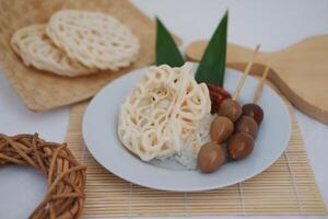rice with skewered quail eggs and crackers on wood background. Selective focus. photo