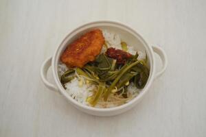 Rice with corn omelette and kale in white bowl on the table photo