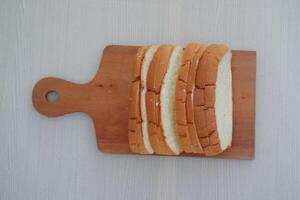 Sliced bread on a wooden cutting board photo