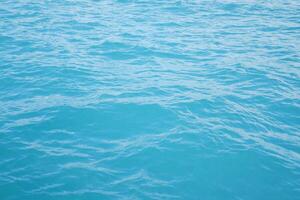 Blue sea water background. Texture of sea water surface with waves. photo