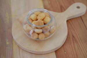 a traditional cake from Indonesia called kue sus filled with cream puffs. served on jar photo