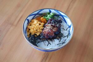 japan style beef with rice and vegetables on wooden table. photo