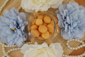 a traditional cake from Indonesia called kue sus filled with cream puffs. served on jar photo