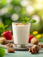 refreshing summer smoothie with walnuts, mint and strawberries on a wooden tray. photo