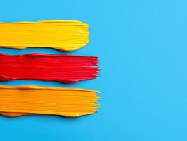 abstract yellow red and blue paint strokes on turquoise background. photo