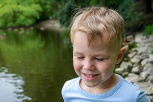 Small boy playing on a pond. photo