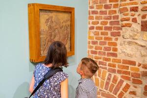 Young boy observing with interest sculptures photo