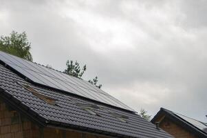 House roof with photovoltaic modules. photo