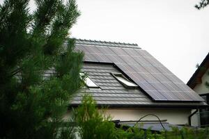 House roof with photovoltaic modules. photo