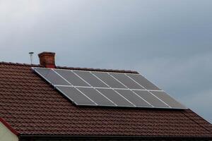 House roof with photovoltaic modules. photo