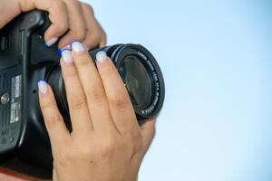 Young photographer taking a picture with is camera photo