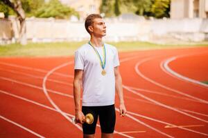 A track runner is standing at the starting line, getting ready for a quick sprint photo