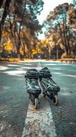 Inline skates on a park pathway with autumn trees in the background. Concept of outdoor activity, rollerblading, leisure, nature. Vertical photo