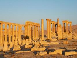 The Bel Temple in Palmyra, Syria, is an ancient architectural marvel. Majestic columns and intricate carvings adorn its facade, reflecting a blend of Roman and Semitic influences. The temple, dedicate photo