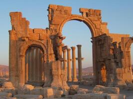 The Bel Temple in Palmyra, Syria, is an ancient architectural marvel. Majestic columns and intricate carvings adorn its facade, reflecting a blend of Roman and Semitic influences. The temple, dedicate photo