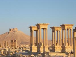 The Bel Temple in Palmyra, Syria, is an ancient architectural marvel. Majestic columns and intricate carvings adorn its facade, reflecting a blend of Roman and Semitic influences. The temple, dedicate photo