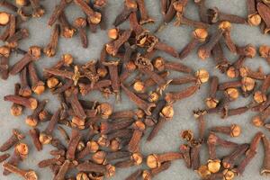 Clove spice heap on a gray background photo
