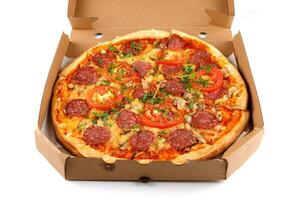 Pizza with sausage in a box on a white isolate. Pizza in delivery box on white background. photo