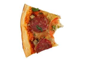 A piece of pizza is bitten. Pizza with salami and tomatoes isolate. photo