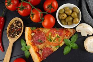 Sliced pizza with vegetables. Pizza on the table photo