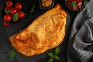 Chebureks with meat. Fried in oil chebureks with meat and herbs. Street food photo