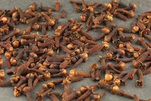 Clove spice heap on a gray background photo