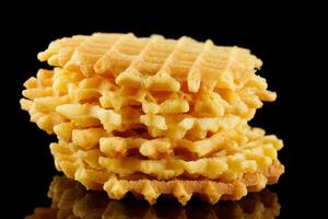 Belgian waffles on a black background. Viennese wafers on an empty photo