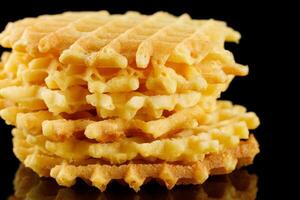 Belgian waffles on a black background. Viennese wafers on an empty photo