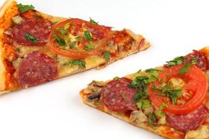 Sliced pizza on white isolate. Two slices of pizza photo