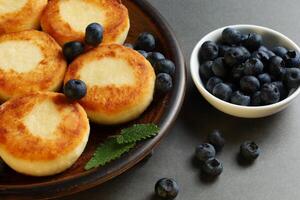 curd fritters with blueberry berry. Tasty and healthy homemade food. photo