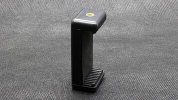 Tripod U holder for smart phone and camera isolated photo